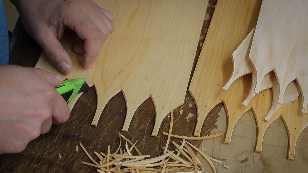 Craftsman shaping swallowtail joints for a handcrafted Shaker box in Maine, perfect for needlework and sewing storage.
