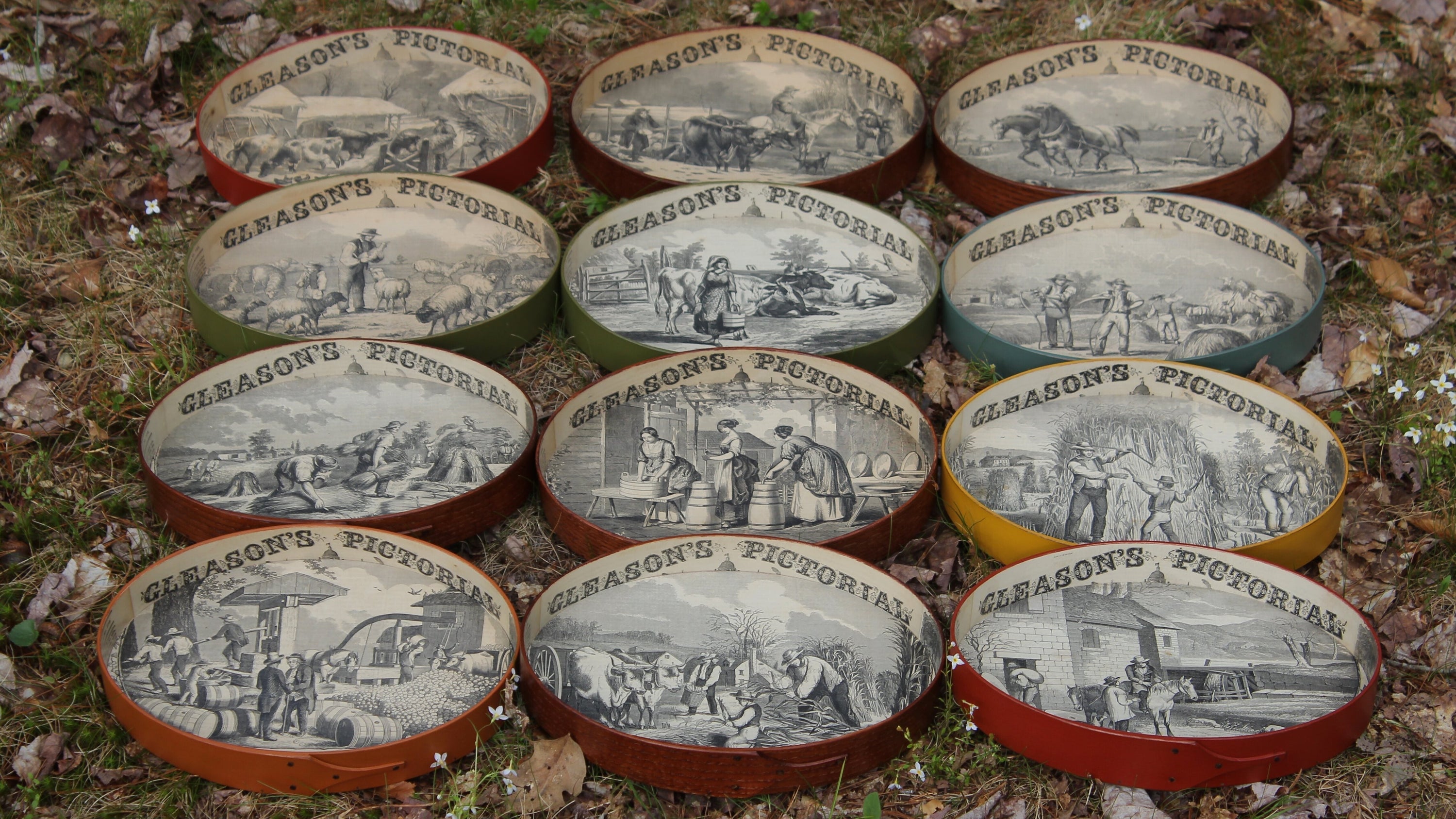 Twelve handcrafted Shaker oval trays, each lined with a different 1854 Gleason's Pictorial farm scene, made in Embden, Maine.