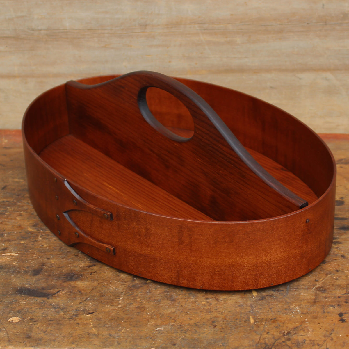 A Shaker divided carrier in an antiqued natural finish