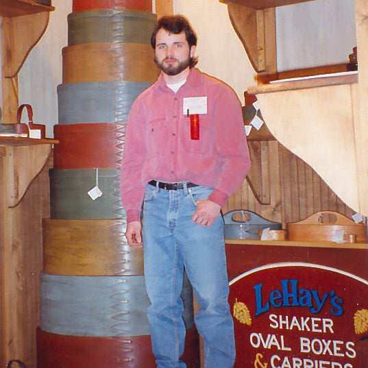 Rob holding a tall graduated stack of natural oval boxes