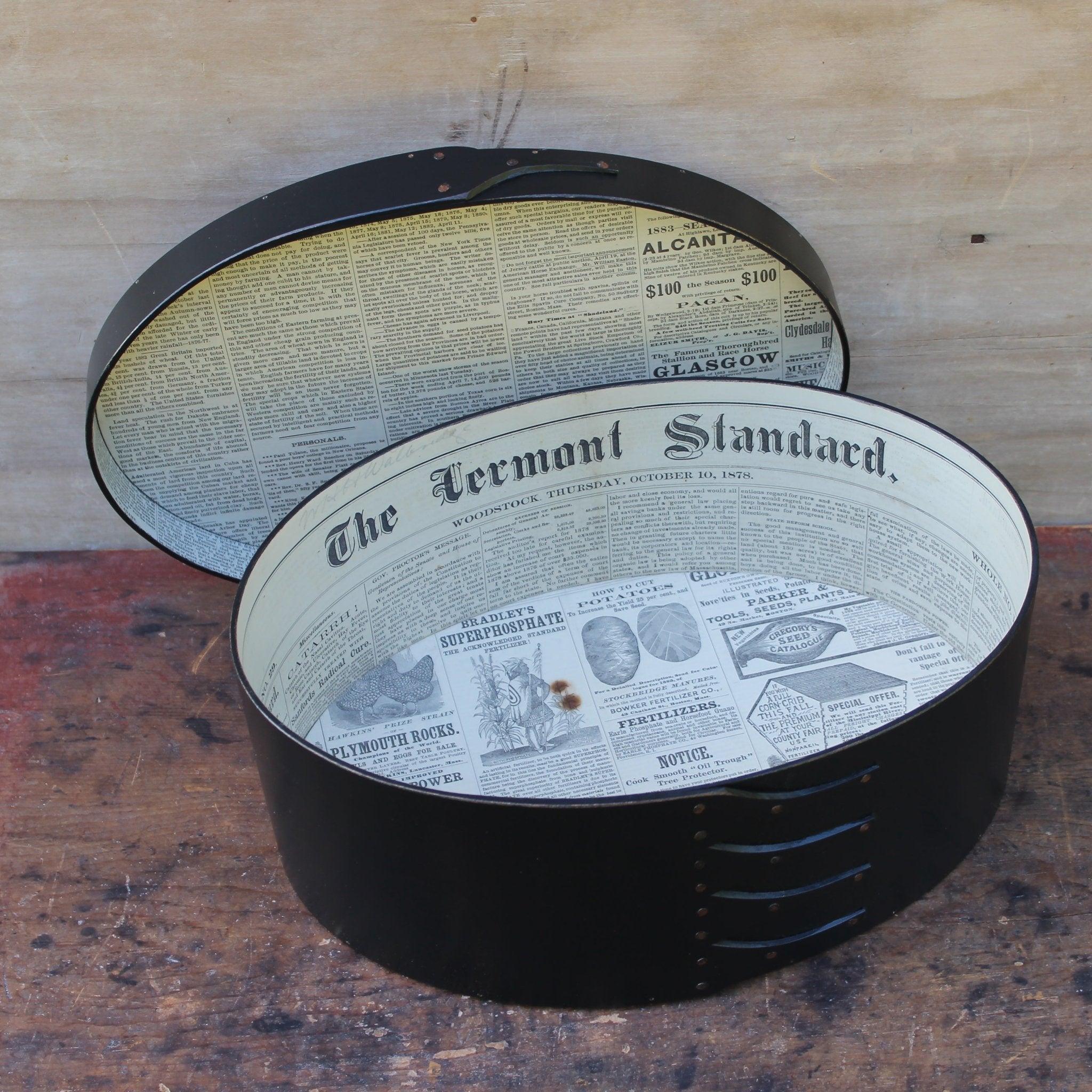 Shaker box with vintage 19th century newspaper lining, black milk paint finish.