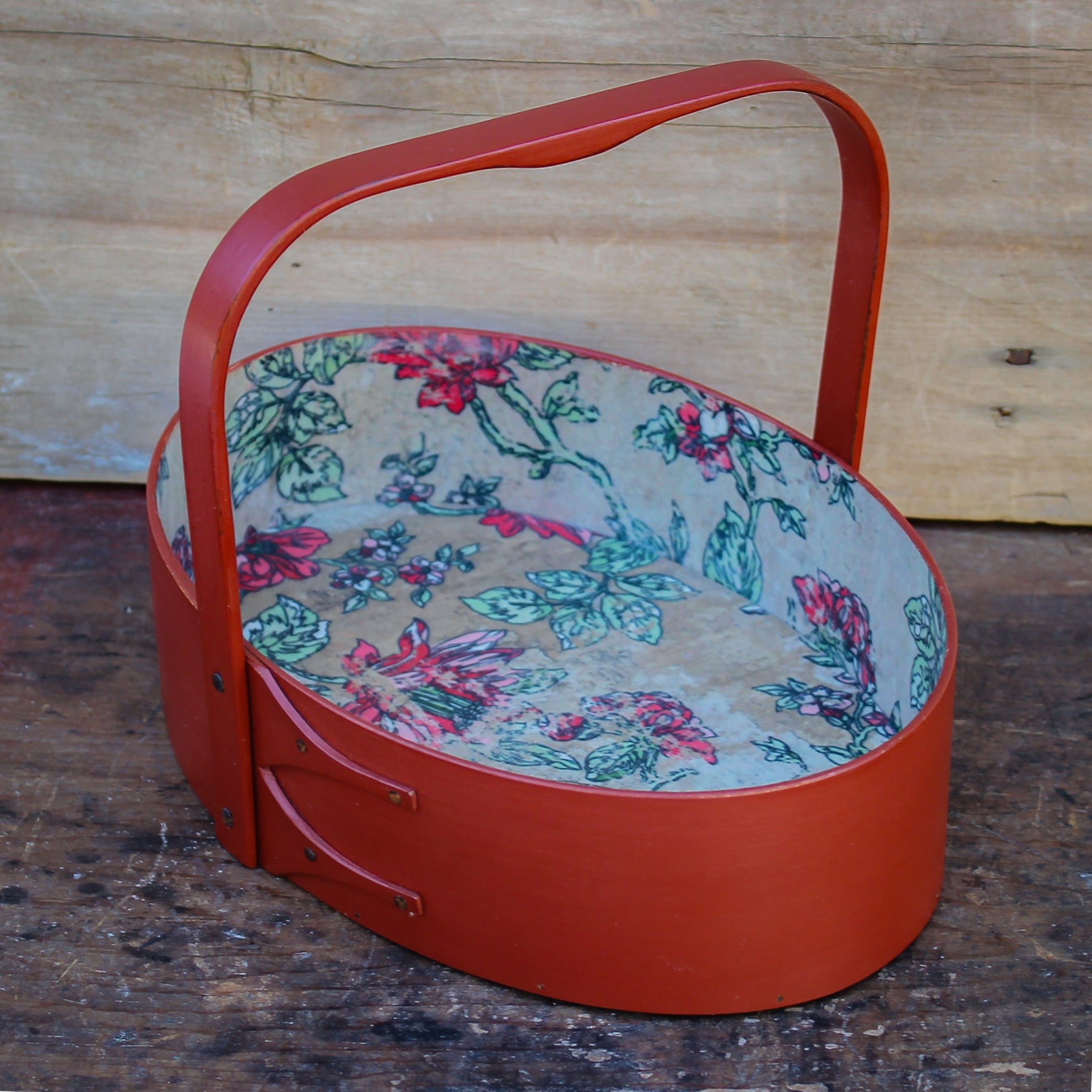 Oval handcrafted Shaker carrier with paper lining, for sewing or storage.