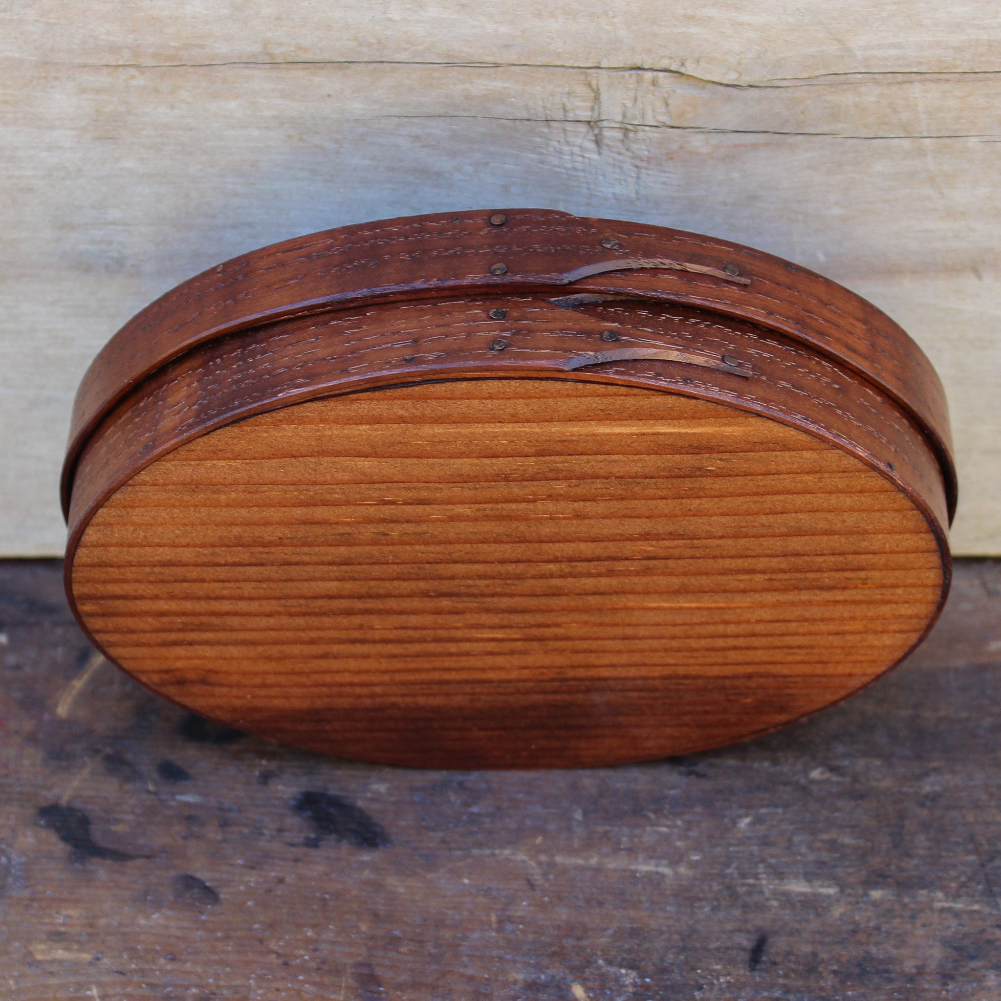 Handcrafted wooden oval shaker box from Maine, perfect for needlework and sewing storage.