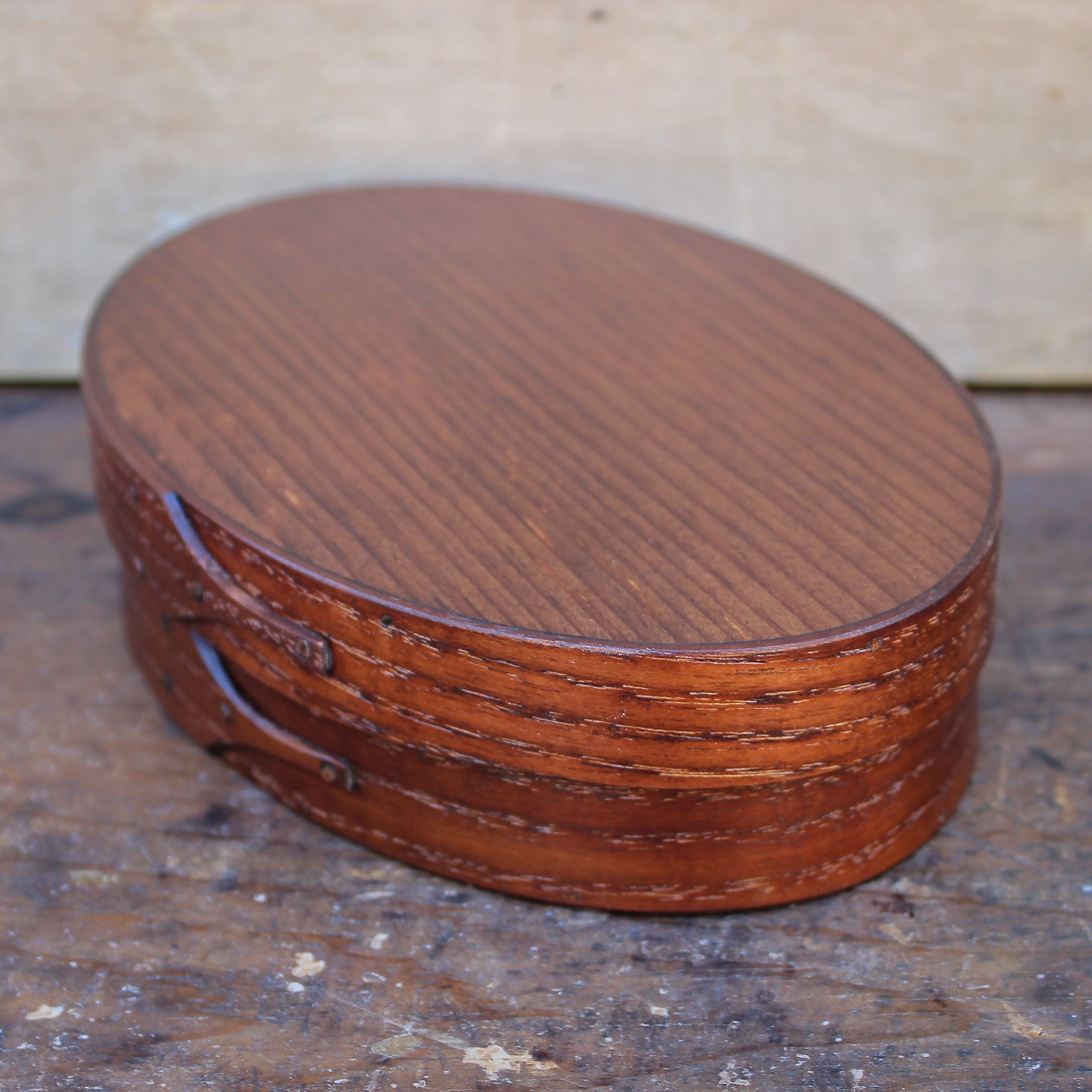 Handcrafted wooden oval Shaker box from Maine, perfect for storing sewing supplies and needlework tools.