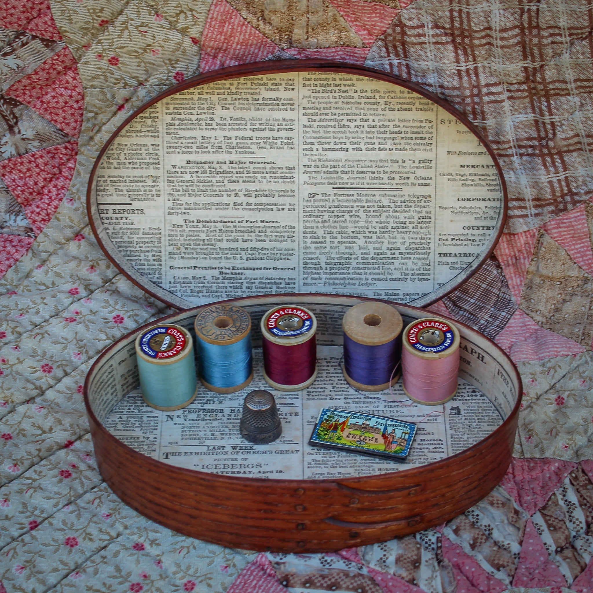 Handcrafted shaker box from Maine, featuring sewing supplies and colorful thread spools for needlework.