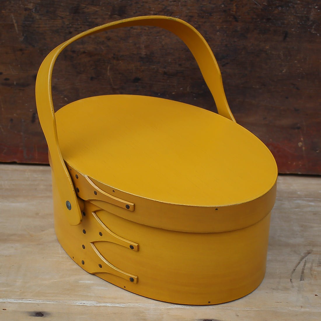 Handcrafted wooden sewing basket with Shaker swing handle, traditional style sewing organizer, made in Maine.