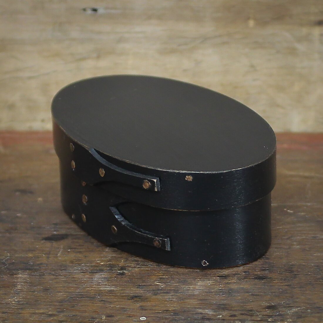 Handcrafted wooden oval shaker box from Maine, ideal for sewing and needlework storage.