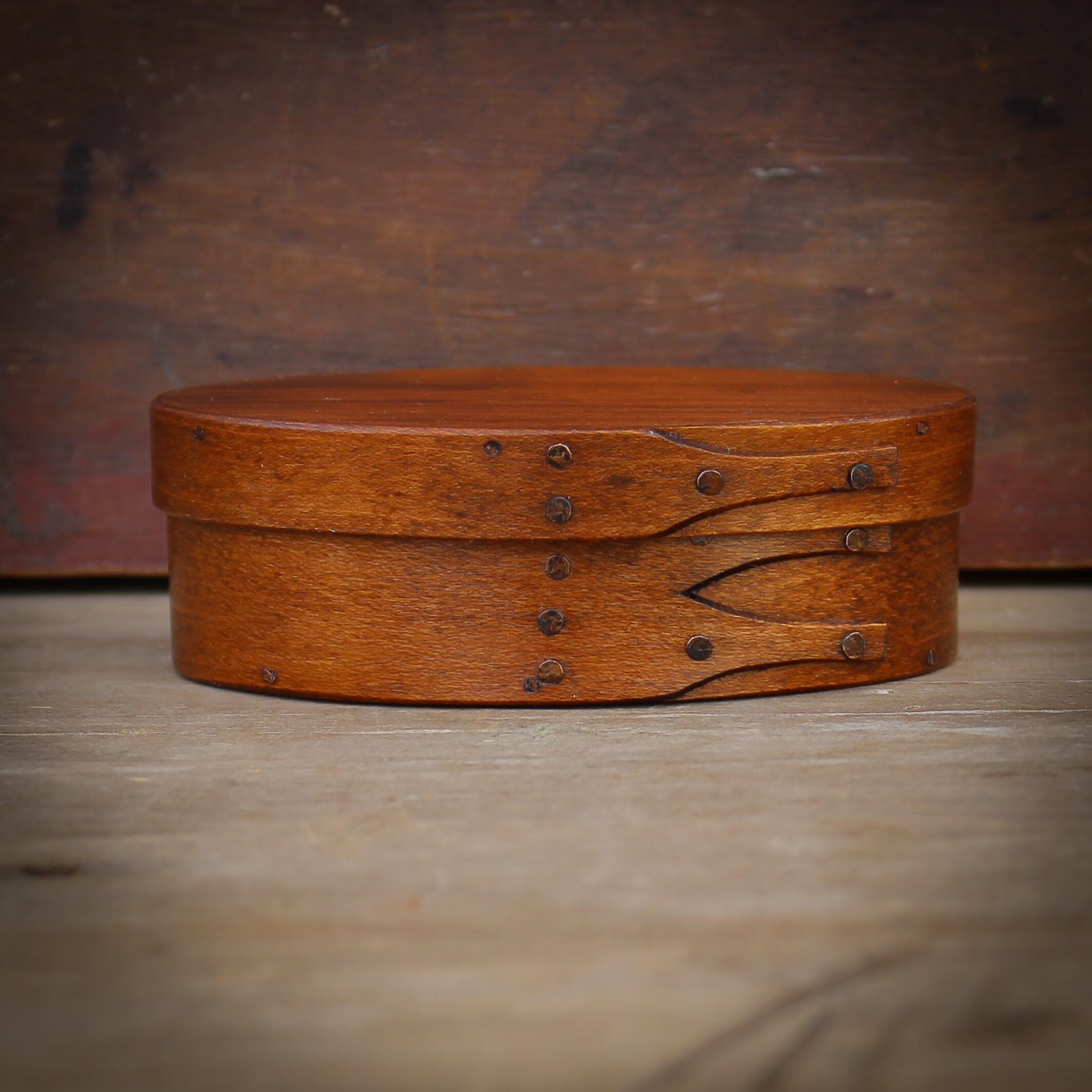 Handcrafted wooden oval Shaker box from Maine, perfect for sewing and needlework accessories.