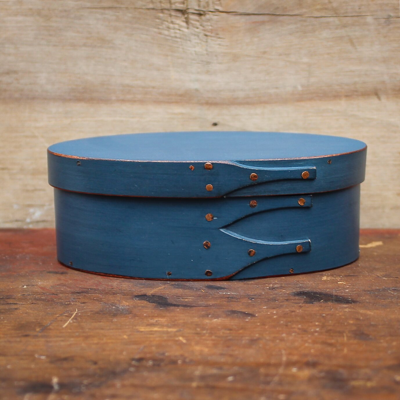 Handcrafted blue wooden oval sewing box from Maine, perfect for needlework and storage, featuring antique-inspired design.
