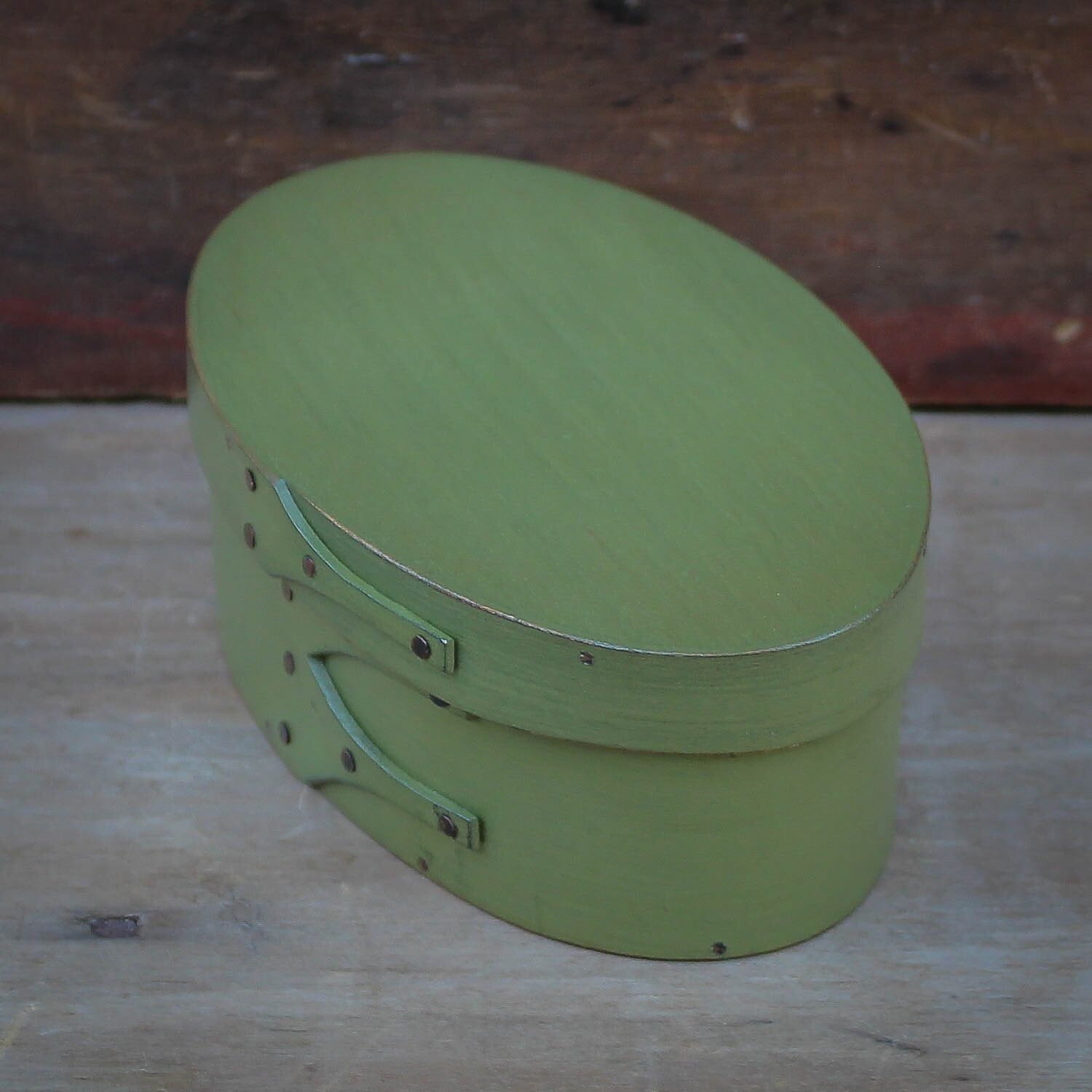 Handcrafted wooden oval sewing box in green, perfect for needlework, made in Maine.