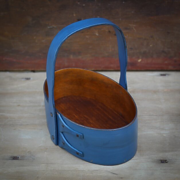 Handcrafted wooden Shaker carrier basket from Maine with fixed handle, perfect as a holiday ornament.