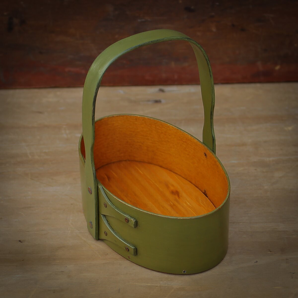 Handcrafted wooden shaker carrier basket with a fixed handle, made in Maine, perfect as a holiday ornament.