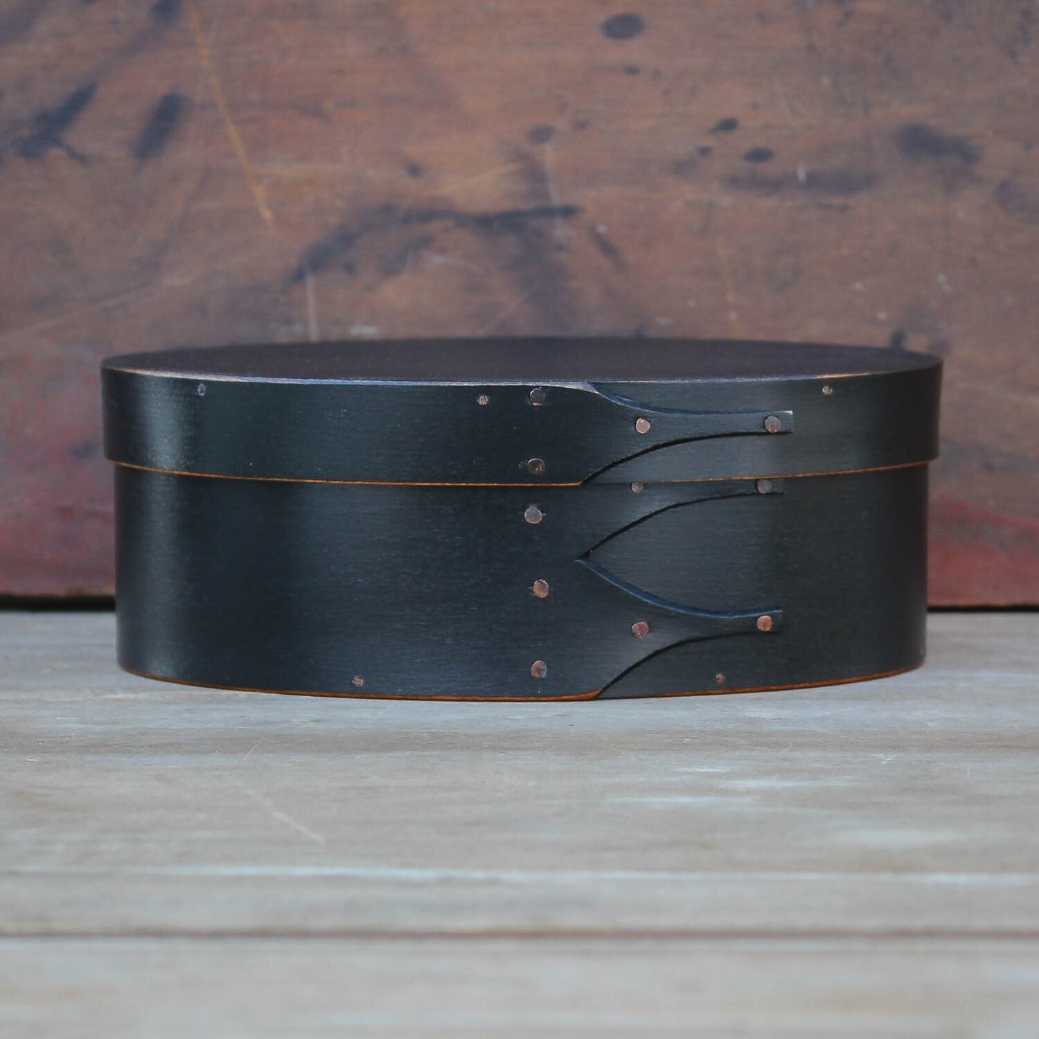 Handcrafted wooden oval Shaker box from Maine, perfect for needlework and sewing storage.