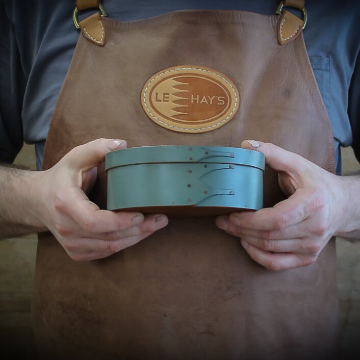 Handcrafted wooden shaker box in hands, perfect for sewing and needlework, made in Maine.