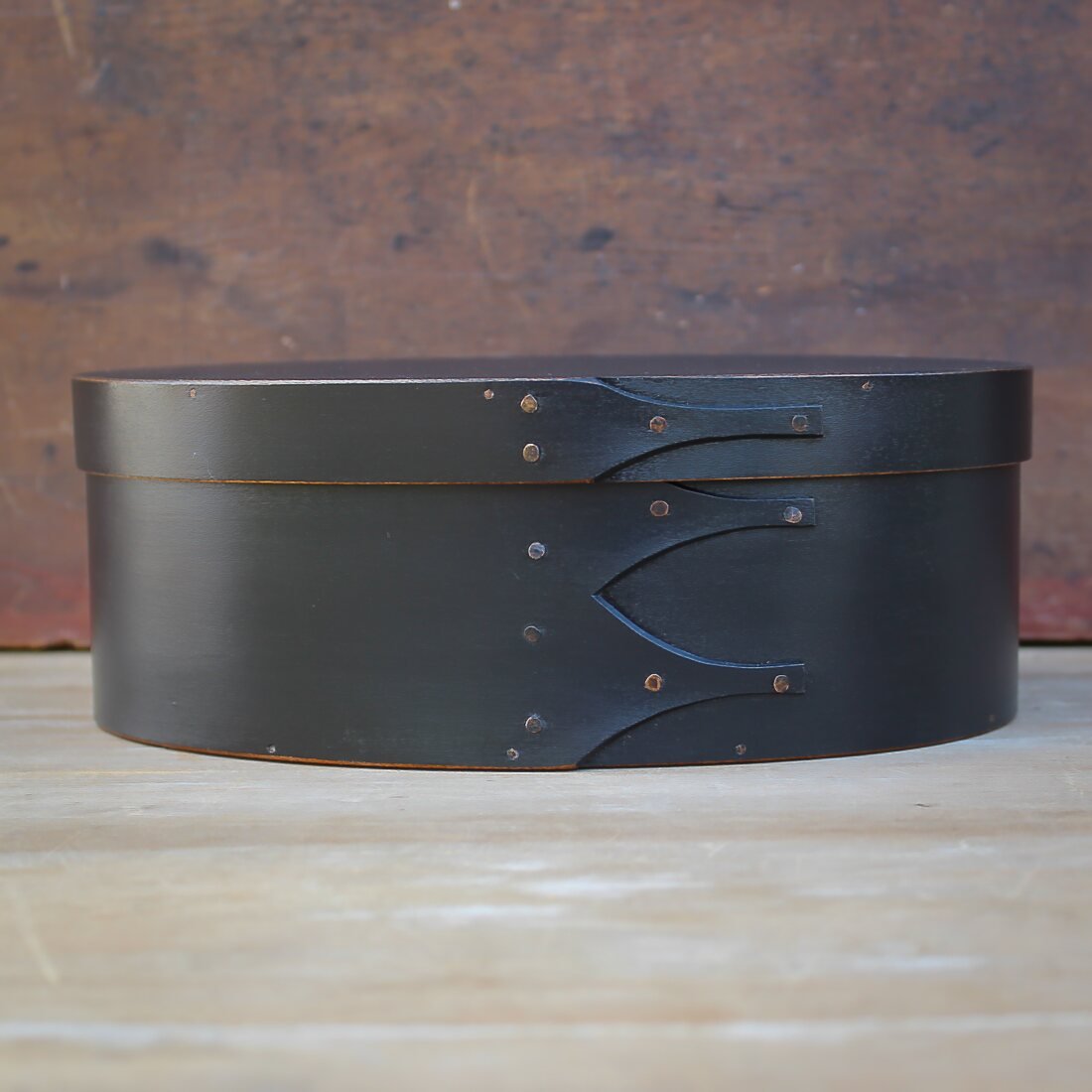 Handcrafted wooden oval shaker box from Maine, ideal for needlework and sewing storage.