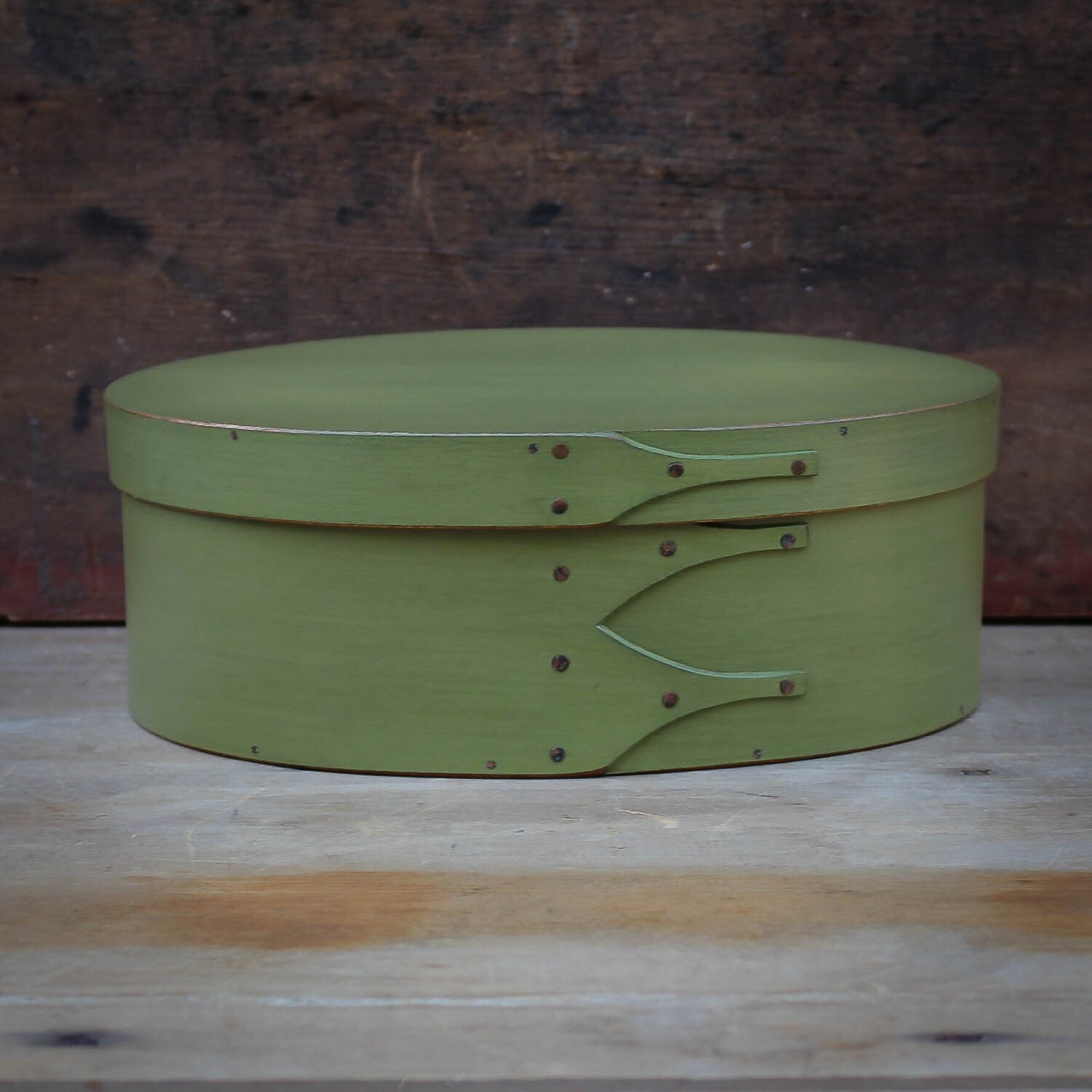 Handcrafted wooden oval shaker box in green, ideal for sewing and needlework, made in Maine.