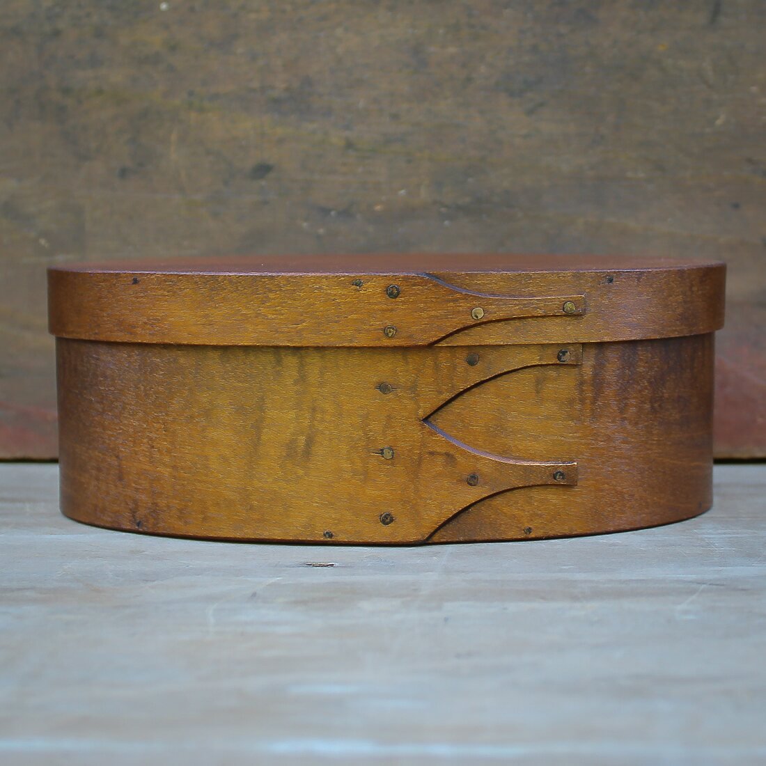 Handcrafted wooden oval shaker box from Maine, ideal for needlework and sewing projects.