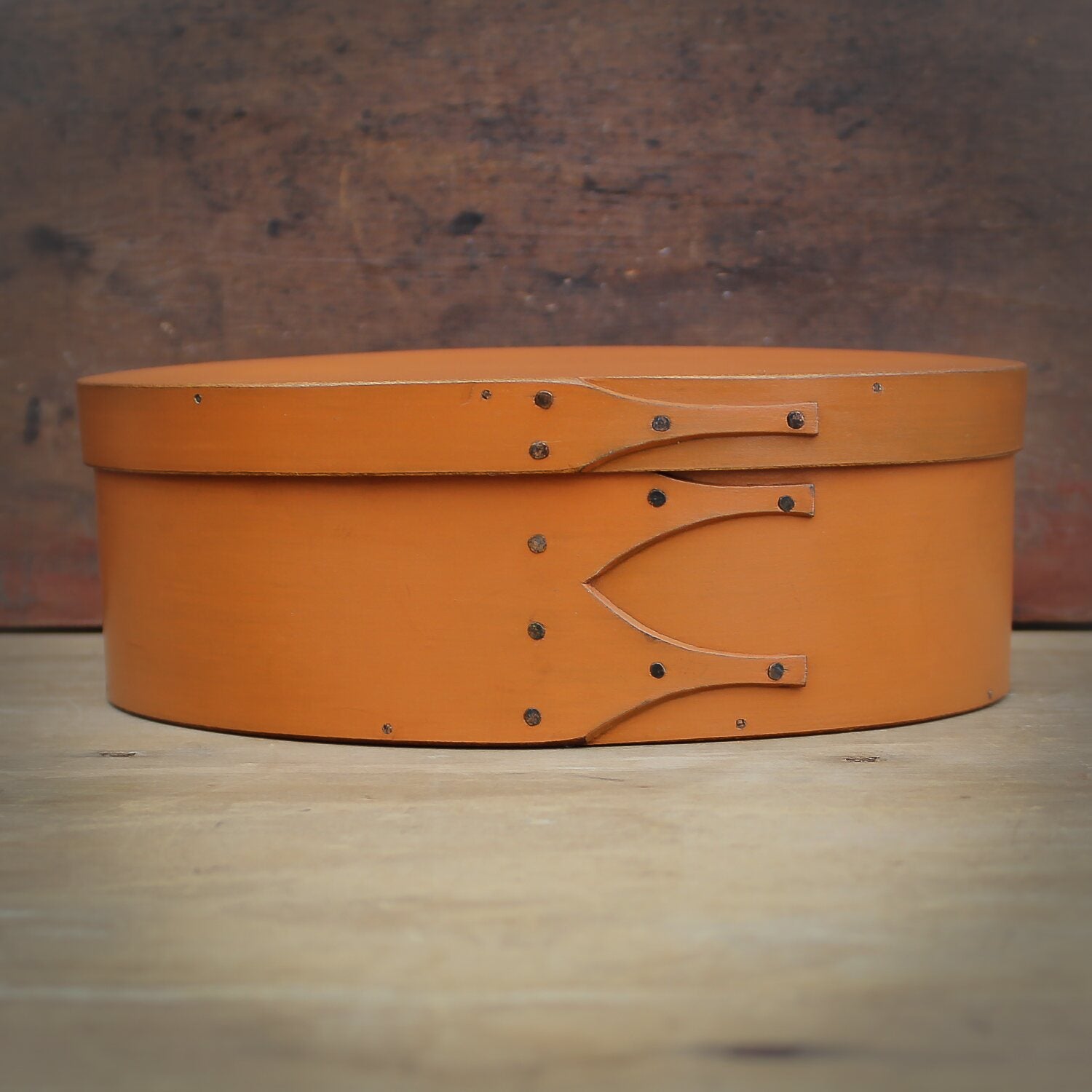 Handcrafted wooden oval Shaker box in pumpkin, ideal for sewing and needlework, made in Maine.