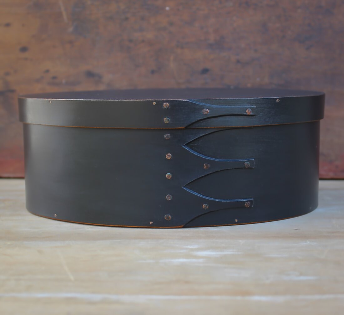 Handcrafted wooden oval shaker box from Maine, ideal for sewing and needlework storage.