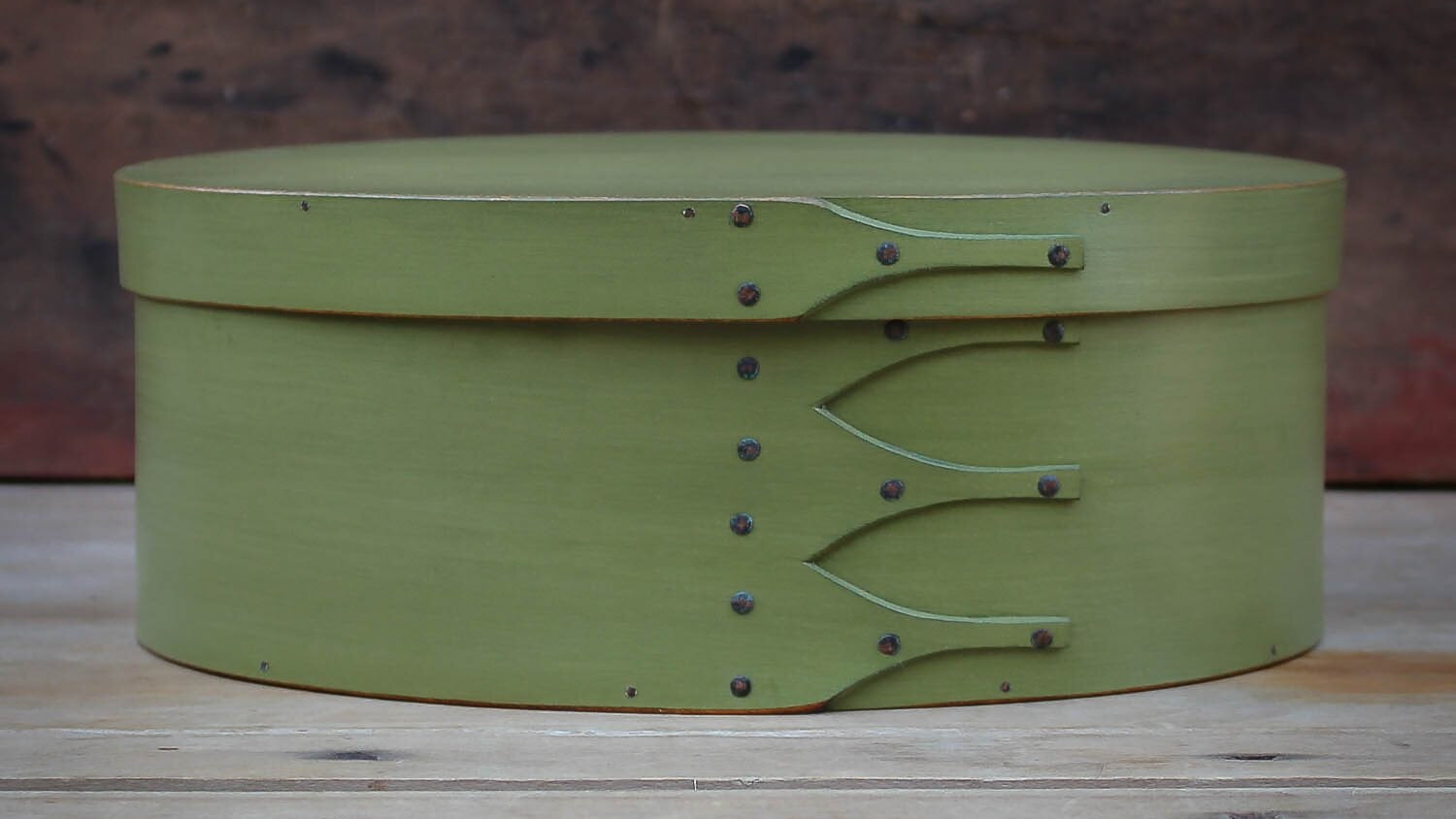 Handcrafted wooden oval shaker box in green, ideal for sewing and needlework, made in Maine.