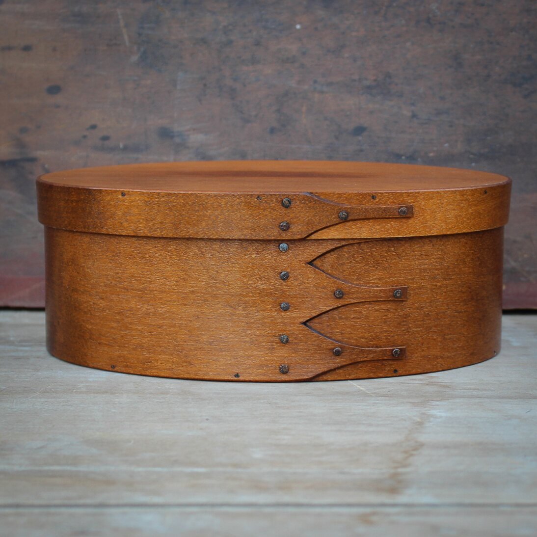 Handcrafted wooden oval Shaker box from Maine, ideal for needlework and sewing essentials.