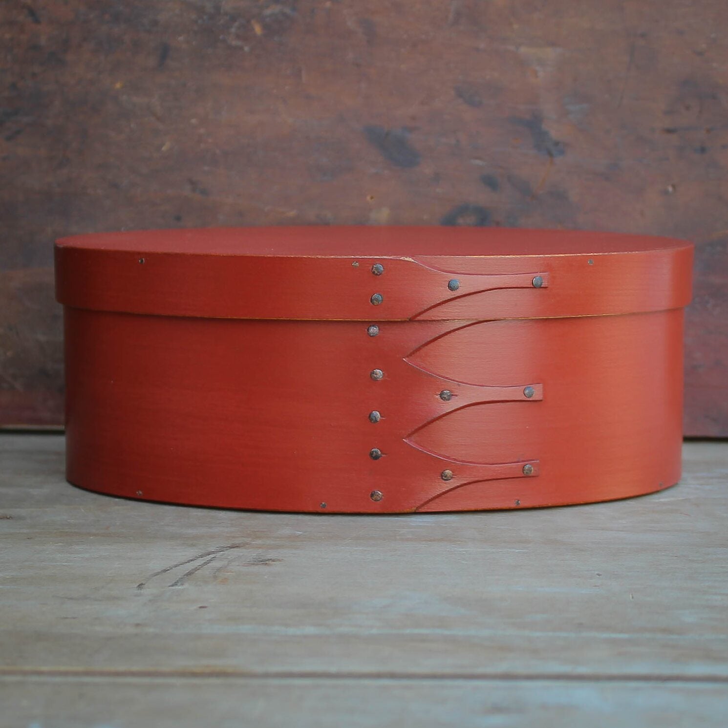 Handcrafted wooden oval Shaker box from Maine, perfect for sewing and needlework storage.