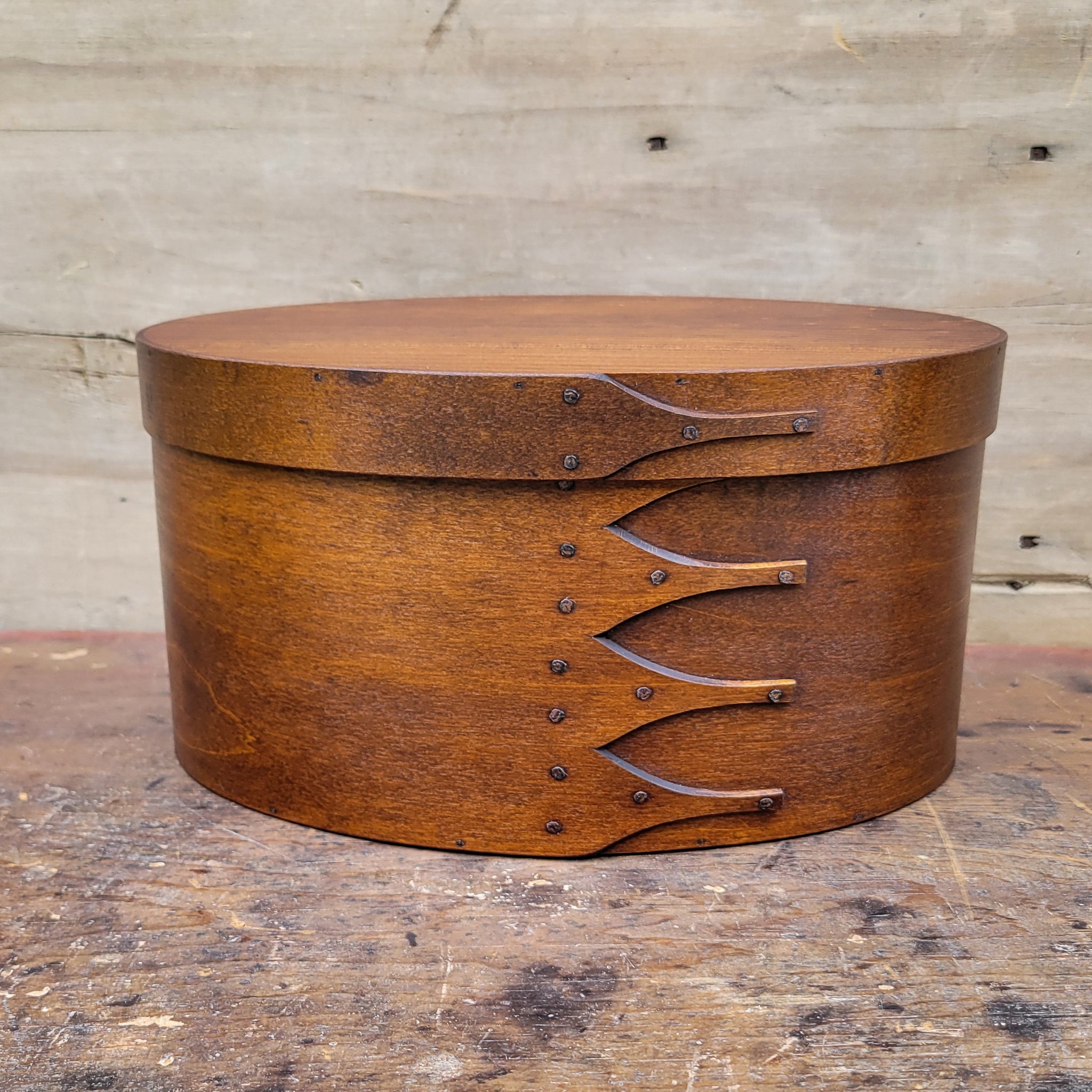 Handcrafted wooden oval shaker box from Maine, perfect for needlework and sewing storage.