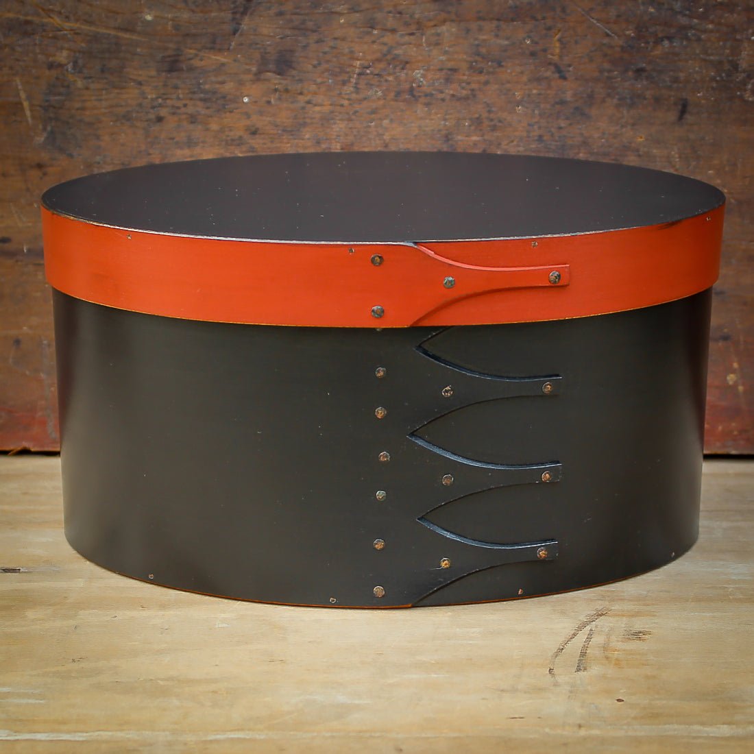 Handcrafted wooden oval shaker box in black and red, ideal for sewing and needlework, made in Maine.