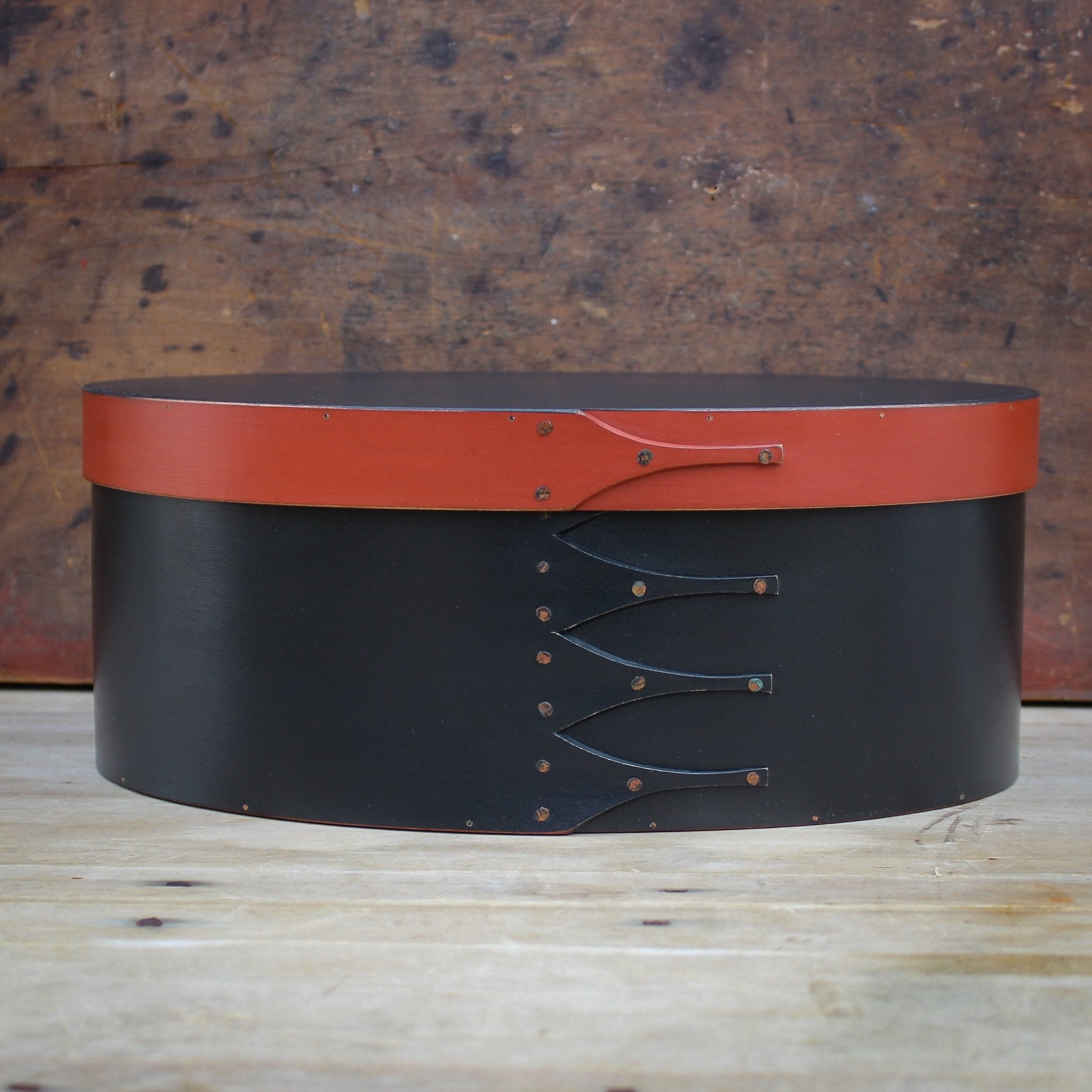Handcrafted wooden oval shaker box from Maine, ideal for sewing and needlework storage.