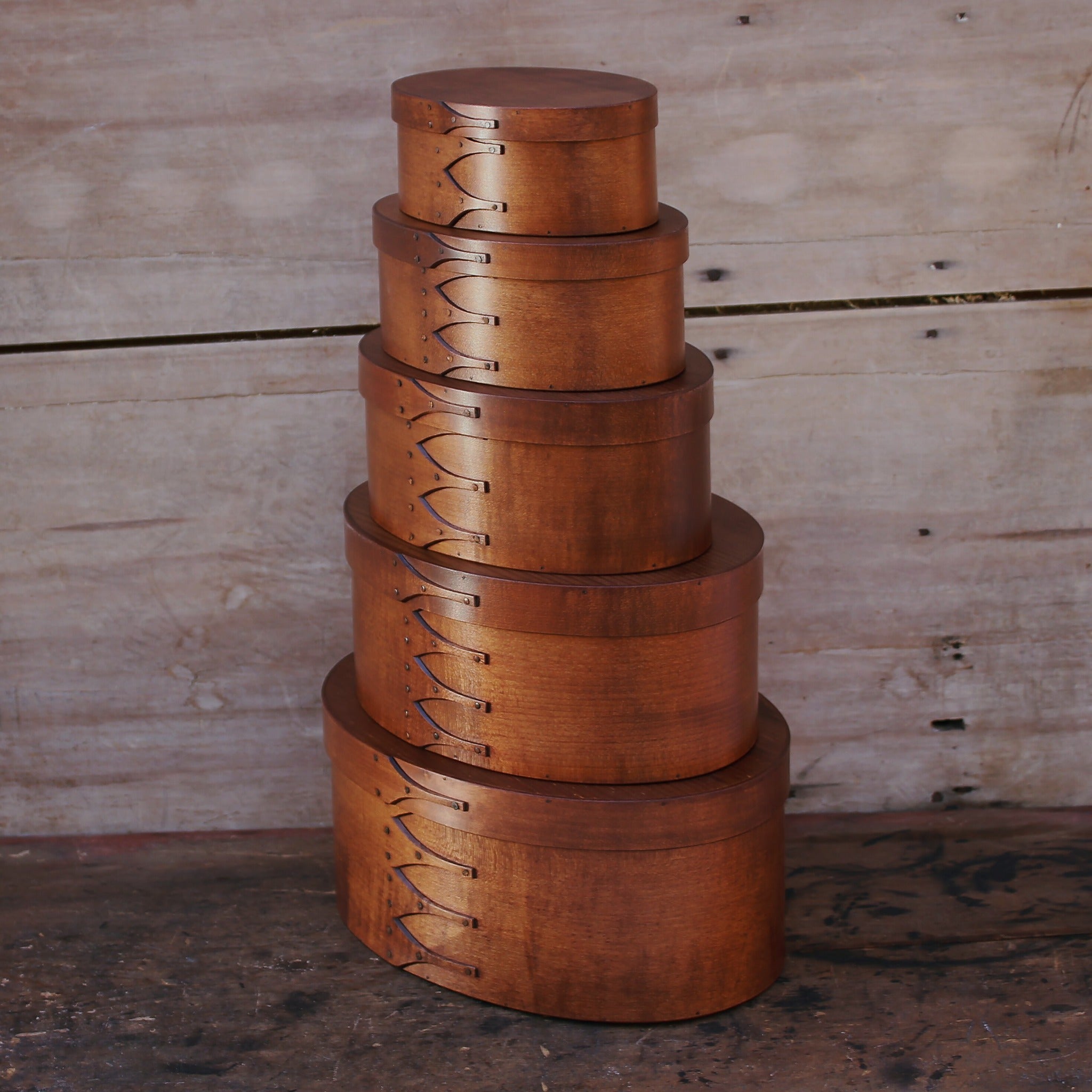 Graduated stack of Shaker oval boxes in antiqued natural finish — LeHay's Shaker Boxes