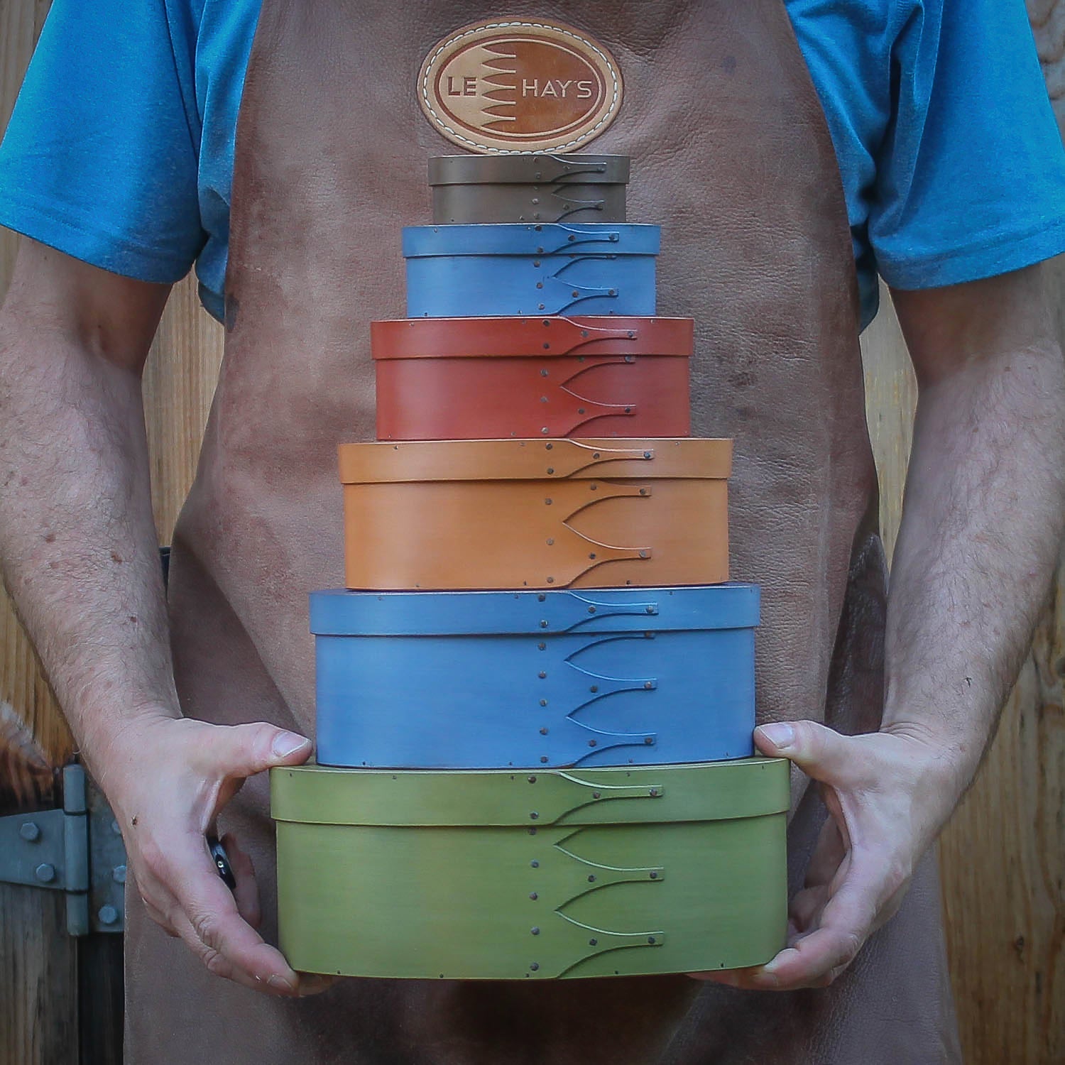 Graduated stack of handcrafted Shaker oval boxes in milk paint finishes — LeHay’s Shaker Boxes