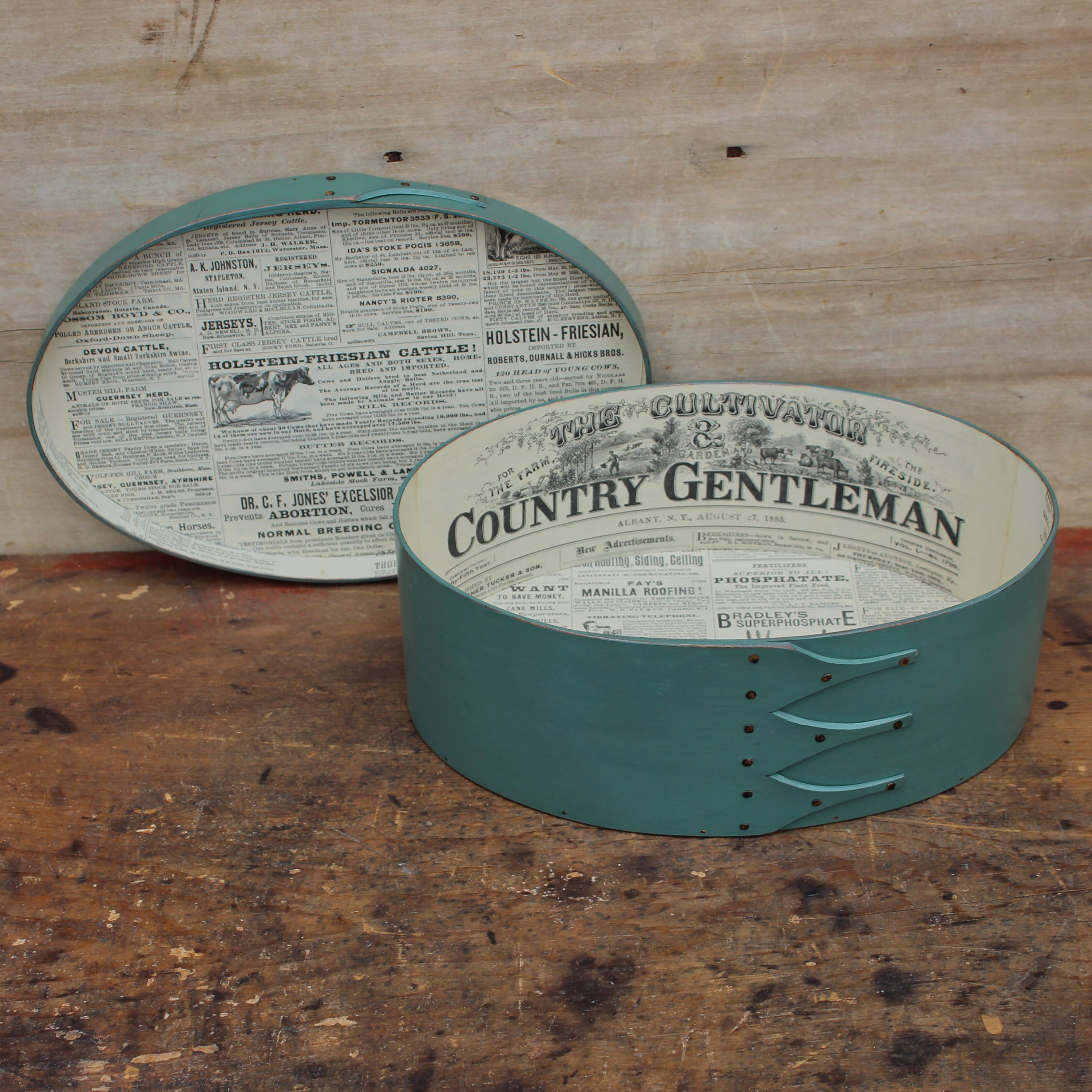 A paper-lined oval box in sea green milk paint, lid off