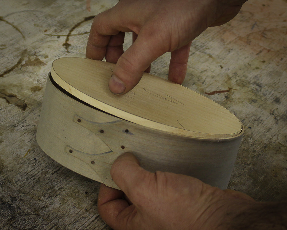 Fitting the oval pine board into a bent band