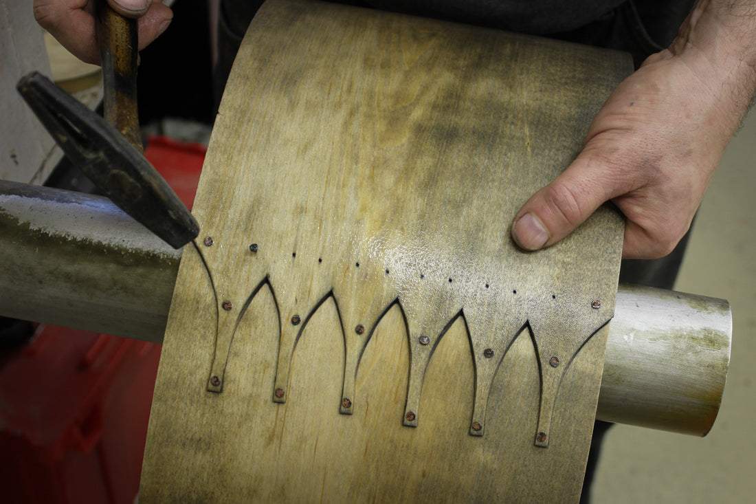 Copper tacks going into hand-cut swallowtail joints